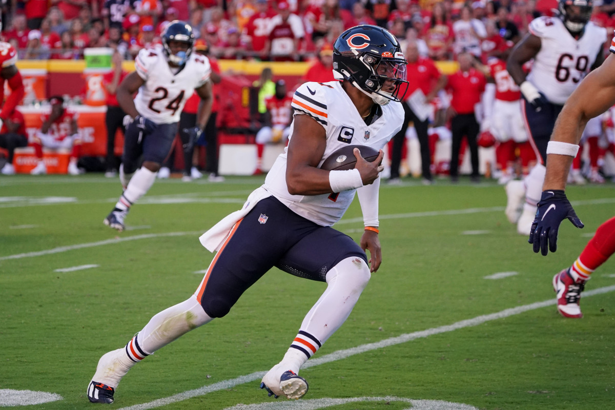 Justin Fields runs with the ball in one hand